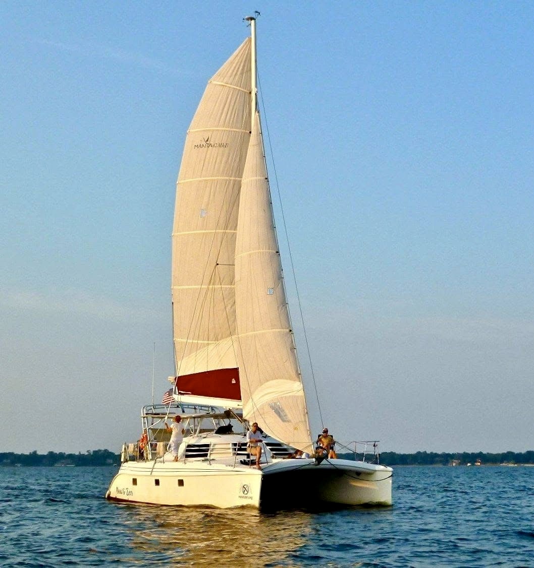 Now and Zen 42ft catamaran under full sail on the St Johns River Jacksonville