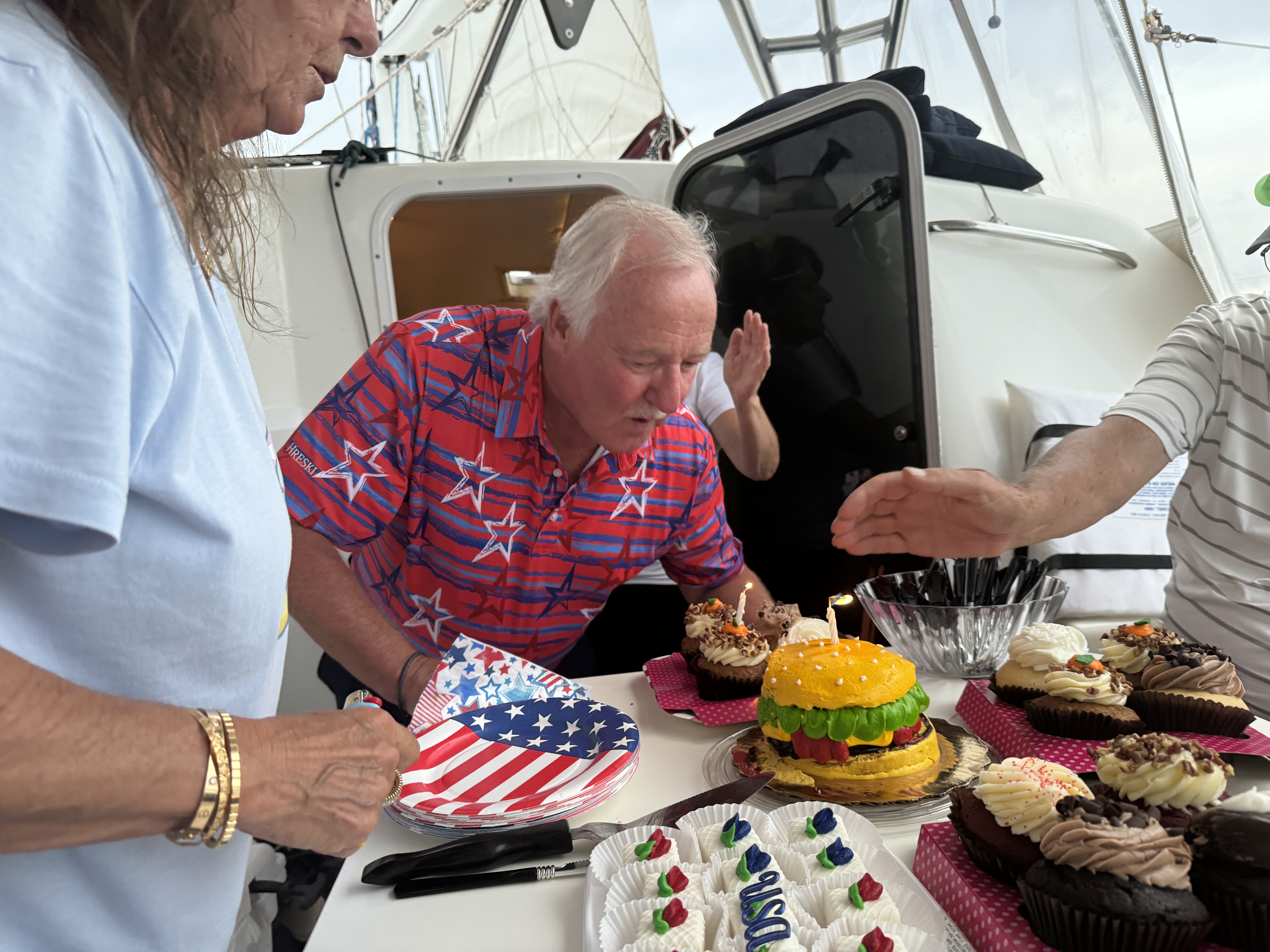 Birthday celebration with cake on the deck of Now and Zen sailing catamaran Jacksonville