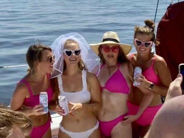 Bachelorette party group in pink celebrating on Now and Zen sailing catamaran Jacksonville